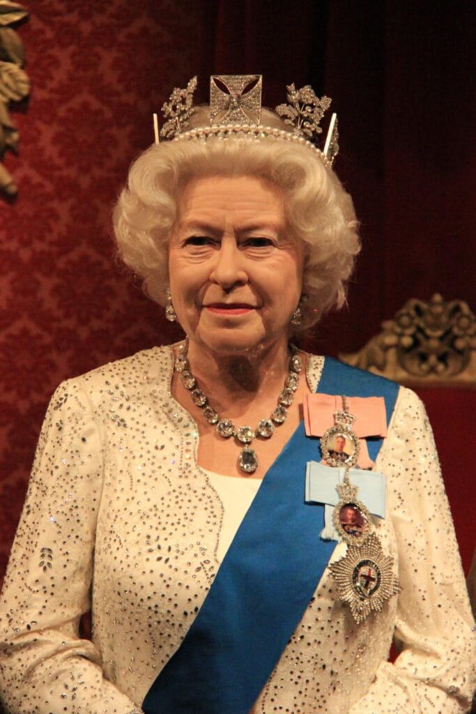 Wheelchair user posing with wax figures inside Madame Tussauds London, surrounded by interactive exhibits