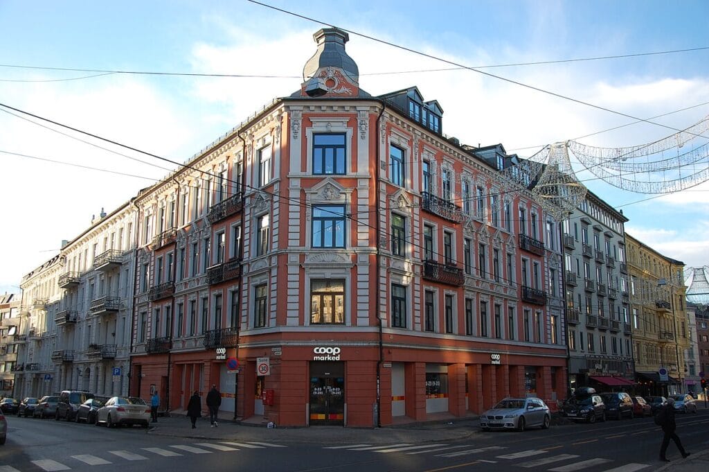 Bogstadveien shopping street in Oslo with trams, shops and pedestrians in a residential West‑side neighborhood