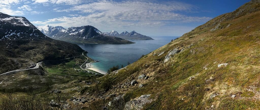 Quiet Norwegian bay backed by mountains near Tromsø, ideal for Northern Lights viewing away from city lights