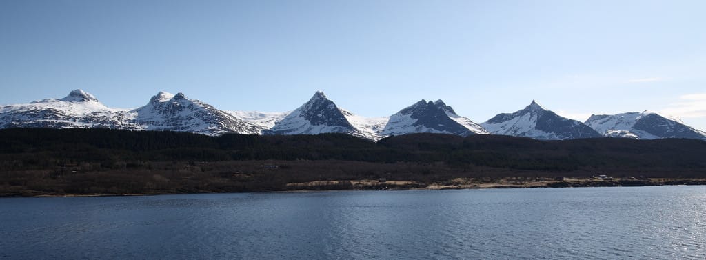 Remote Norwegian fjord backed by the jagged Seven Sisters mountains in Helgeland, a rarely visited area of Norway