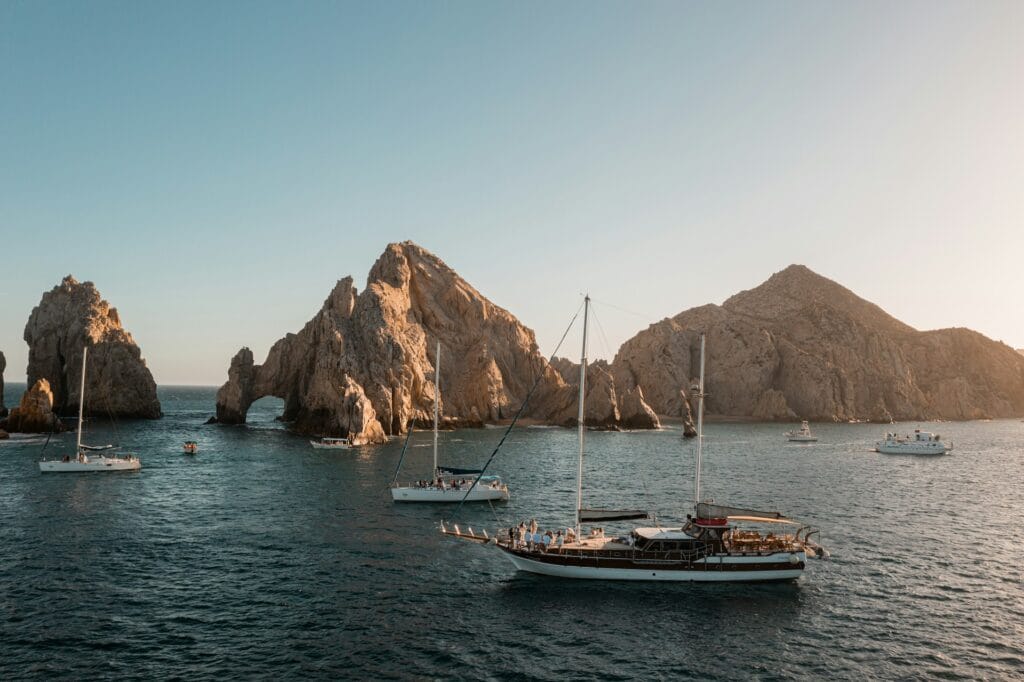 Cabo San Lucas bay with boats and sunset, luxury Mexican all-inclusive resort destination for families
