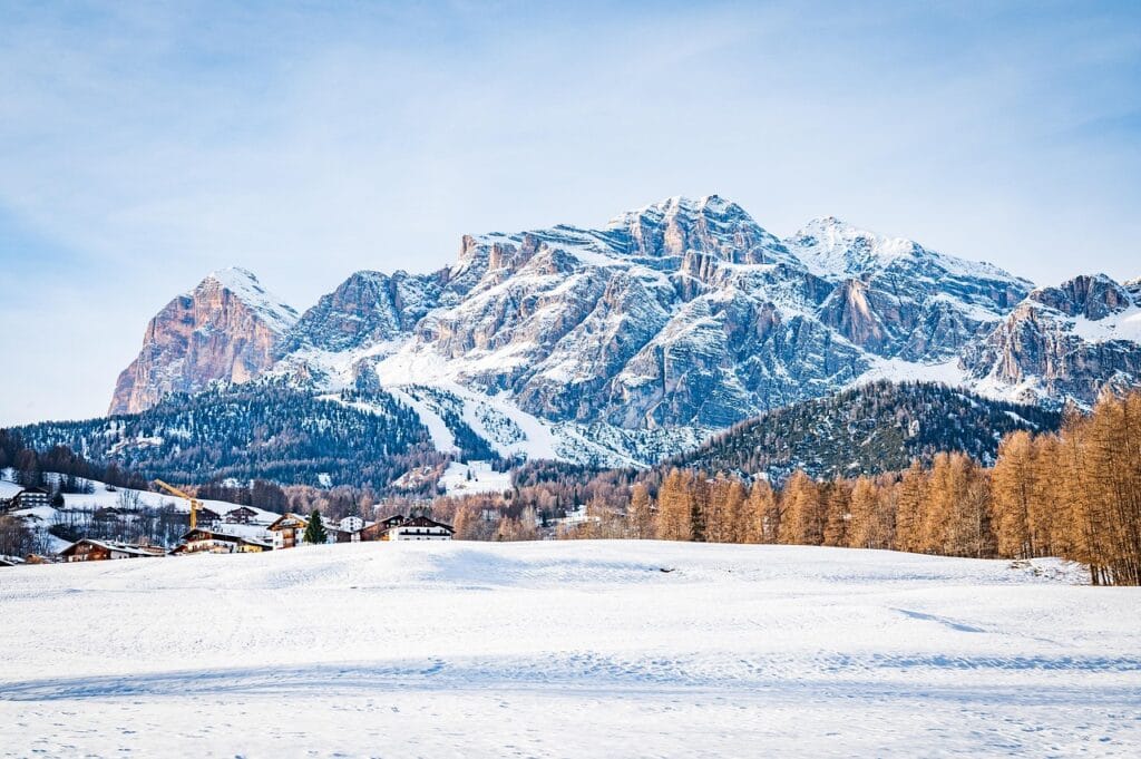 Cortina d'Ampezzo Alpine village nestled in snowy Dolomite mountains with traditional architecture and Olympic venue facilities