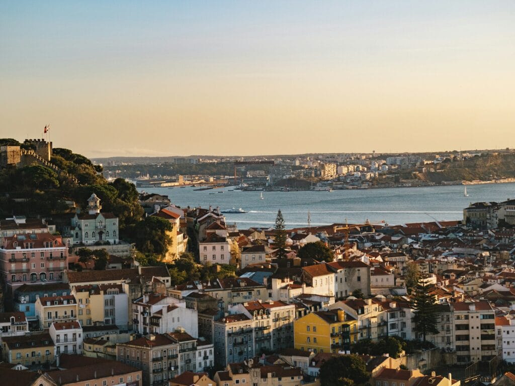 Lisbon Portugal Alfama district with colorful buildings climbing hillside, Europe's cheapest budget destination with quality