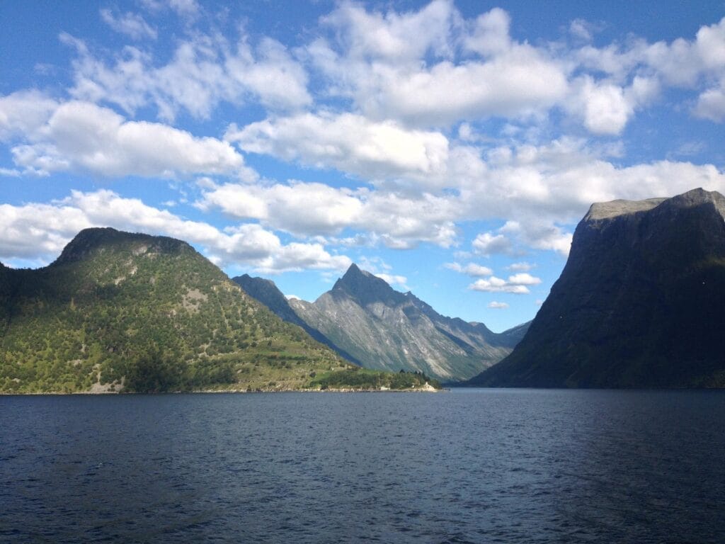 Small village of Sæbø on Hjørundfjord with boats and mountains, showing everyday life in a quiet Norwegian fjord community