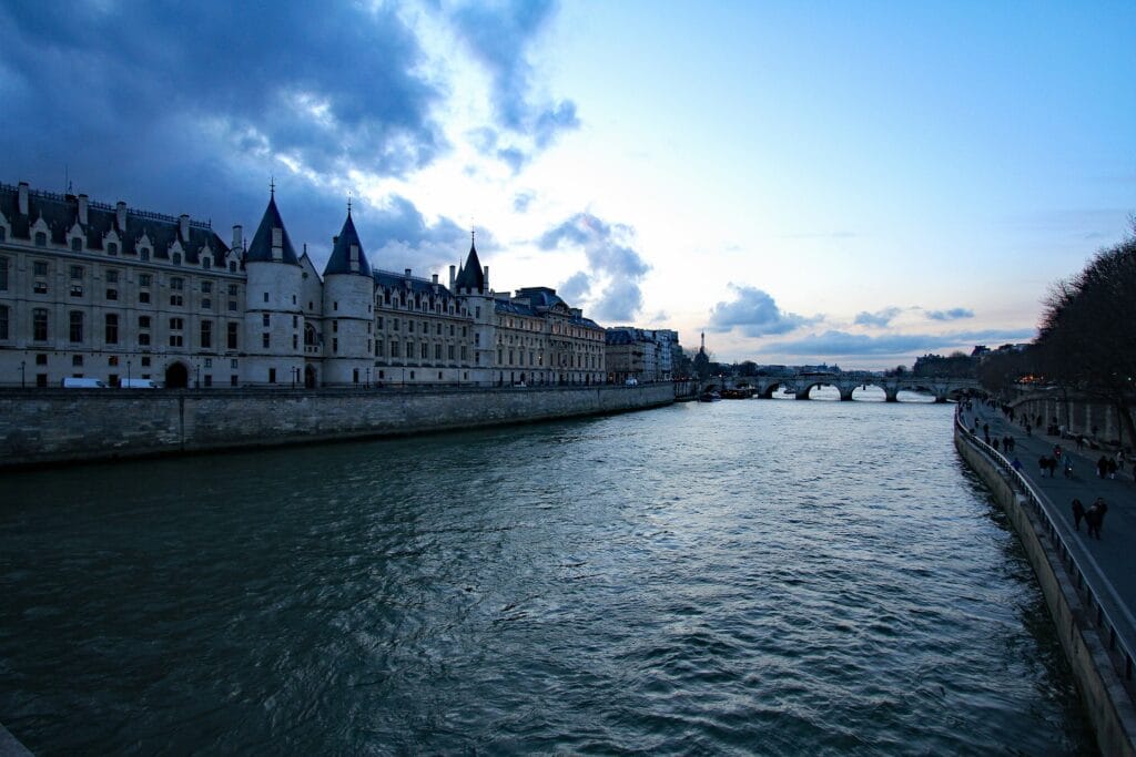 Seine riverside path (Berges de Seine) showing step-free accessible route along river, smooth flat pavement for wheelchair access, bridge architecture visible
