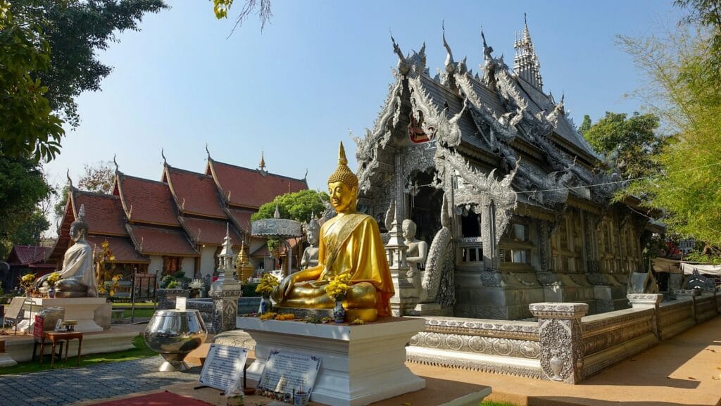 Thailand Chiang Mai golden Buddhist temple with peaceful monks and ornate decorations, cultural budget destination
