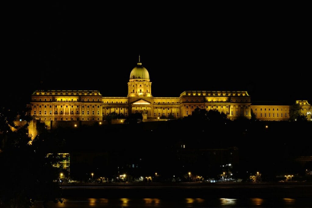 Budapest Parliament building lit up at night with golden dome, Eastern Europe's cheapest beautiful capital city