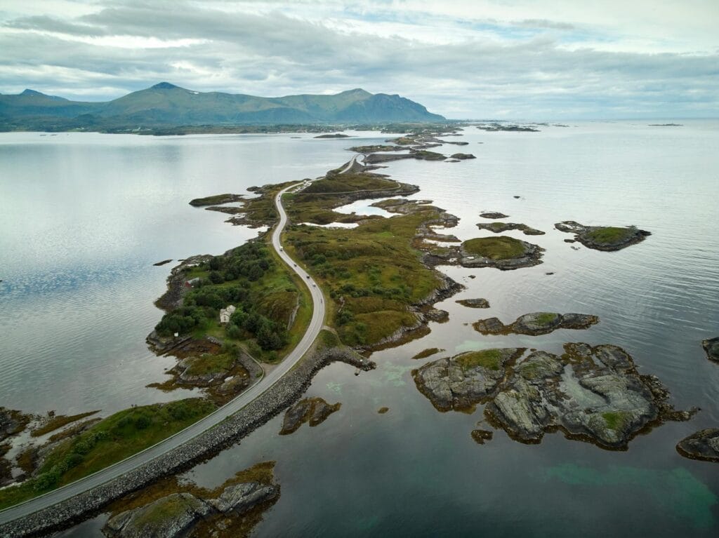 "Aerial view of Norway's Atlantic Ocean Road with dramatic coastal cliffs and fjords, showcasing Norway's nature and safety for solo travelers"