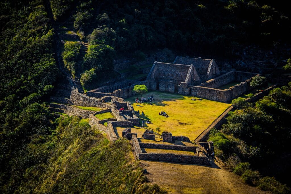 High-angle view of the ancient stone ruins and terraces of the Choquequirao archaeological site in Peru.