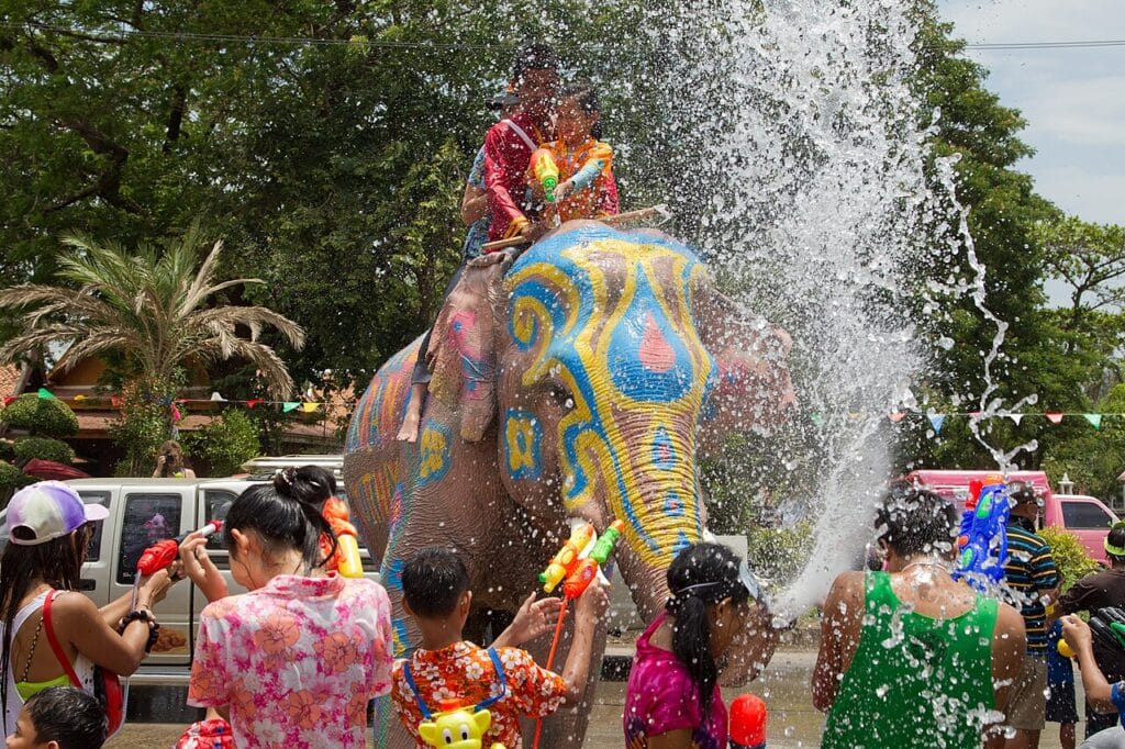 A painted elephant spraying water on people during the Songkran Water Festival in Ayutthaya, Thailand.