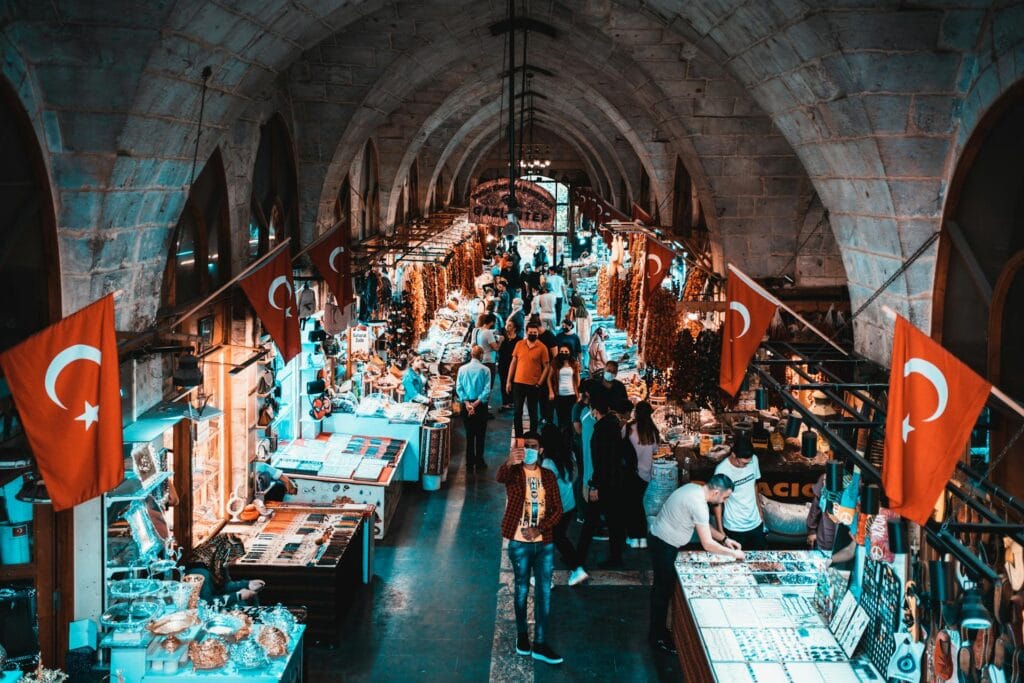 View of a bustling traditional bazaar with spices and crafts inside an arched stone passage in Gaziantep