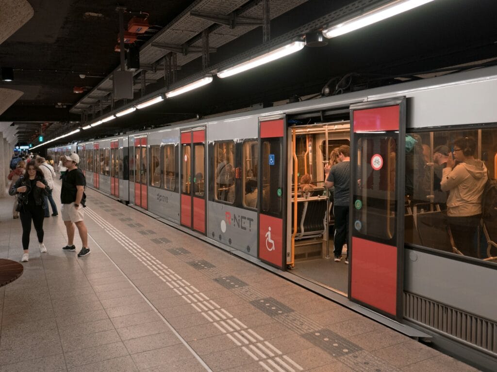 Metro station in Amsterdam with passengers, showing wheelchair-friendly underground transport
