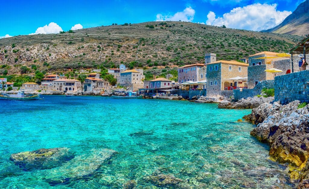 The scenic stone buildings and turquoise coastline of Limeni in the Peloponnese, Greece