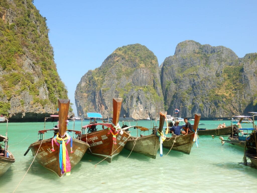 Traditional Thai longtail boats anchored in the turquoise waters of Koh Yao Noi, a quiet destination in Phang Nga Bay.