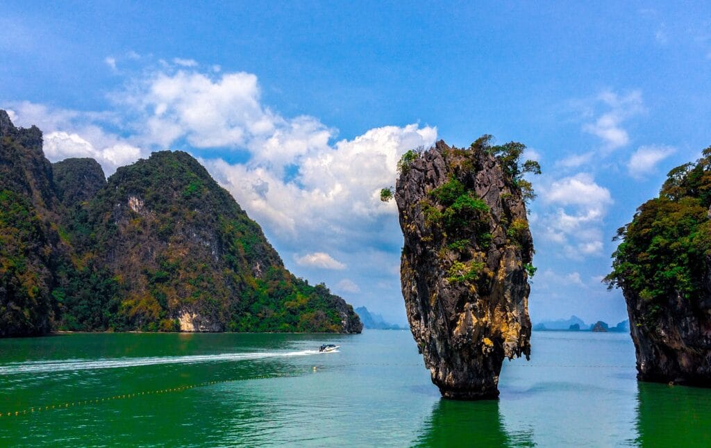 Dramatic limestone karst formations rising from the green waters of Phang Nga Bay, Koh Yao Noi.