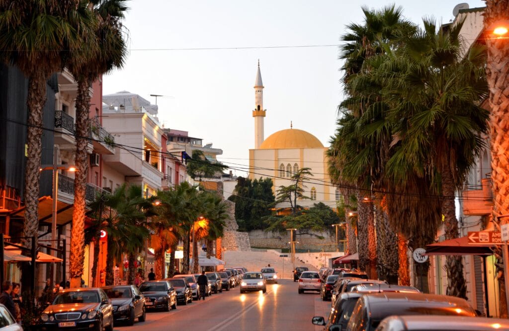 City street view with a historic mosque in Albania during the evening hours
